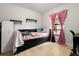 Comfortable bedroom with a day bed, window with curtains, and neutral paint and shelves at 9814 Piney Point Cir, Orlando, FL 32825