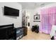 Bedroom space featuring a TV, desk, day bed with decor and doorway access to other rooms at 9814 Piney Point Cir, Orlando, FL 32825