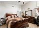 Large main bedroom with wooden furniture, including a bed frame and dresser, with modern light fixtures at 9814 Piney Point Cir, Orlando, FL 32825