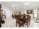 Spacious, tiled dining area with comfortable seating and natural light from nearby windows at 9814 Piney Point Cir, Orlando, FL 32825