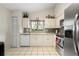 Efficient kitchen with white cabinetry, stainless steel appliances and tiled floor at 9814 Piney Point Cir, Orlando, FL 32825