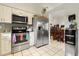Well-lit kitchen with stainless steel appliances, tiled floor, and ample countertop space at 9814 Piney Point Cir, Orlando, FL 32825