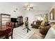 Inviting living room featuring vaulted ceiling, tile floors and comfortable seating arrangements at 9814 Piney Point Cir, Orlando, FL 32825