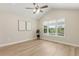 Bedroom with ceiling fan, and a window overlooking the lush landscape at 1031 Morningside Dr, Eustis, FL 32726