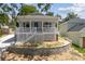 Charming single-story home with a cozy front porch and a blue front door at 1031 Morningside Dr, Eustis, FL 32726