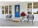 Inviting front porch with a vibrant blue door, comfortable seating, and stylish decor at 1031 Morningside Dr, Eustis, FL 32726