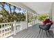 Spacious front porch with ample seating, scenic views, and durable composite flooring at 1031 Morningside Dr, Eustis, FL 32726