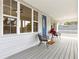 Welcoming front porch with a colorful door, comfortable chairs, and picturesque surroundings at 1031 Morningside Dr, Eustis, FL 32726