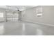 Spacious two car garage with sealed concrete floors and two windows providing natural light at 1031 Morningside Dr, Eustis, FL 32726