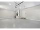 A spacious two car garage is well lit and has a side service door with steps at 1031 Morningside Dr, Eustis, FL 32726