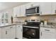 Bright kitchen featuring white cabinets, stainless steel appliances, and granite countertops at 1031 Morningside Dr, Eustis, FL 32726