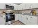 Bright kitchen featuring white cabinets, stainless steel appliances, and granite countertops at 1031 Morningside Dr, Eustis, FL 32726
