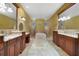 Spacious bathroom with double vanity sinks, a soaking tub, and stone tile floors at 12663 Hawkstone Dr, Windermere, FL 34786