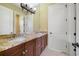 Bathroom featuring granite countertops, dual sinks, and wooden cabinets at 12663 Hawkstone Dr, Windermere, FL 34786