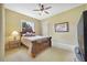 Bedroom with wood bed frame, neutral carpet, ceiling fan and a picture on the wall at 12663 Hawkstone Dr, Windermere, FL 34786