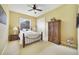 Bedroom with neutral carpet, an iron bed frame, ceiling fan and a wooden armoire at 12663 Hawkstone Dr, Windermere, FL 34786