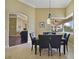 Cozy dining area with stylish black chairs and a view to the outdoor covered lanai at 12663 Hawkstone Dr, Windermere, FL 34786