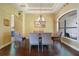 Elegant dining room featuring tray ceilings, decorative chandelier, and large window at 12663 Hawkstone Dr, Windermere, FL 34786