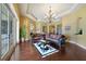 Comfortable living room with hardwood floors, decorative rug, chandelier, and outdoor access at 12663 Hawkstone Dr, Windermere, FL 34786