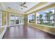 Bright living room featuring beautiful lake views, wood floors, and access to outdoor patio at 12663 Hawkstone Dr, Windermere, FL 34786