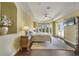 Bright main bedroom featuring a ceiling fan, hardwood floors, and multiple windows with a view at 12663 Hawkstone Dr, Windermere, FL 34786