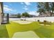 This backyard boasts a custom putting green, a tranquil pond, and a well-maintained fence at 13519 Bicton Ln, Windermere, FL 34786