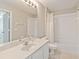Bright bathroom features a vanity, mirror, and shower with tub at 13519 Bicton Ln, Windermere, FL 34786