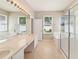 Bright bathroom with double sinks, a glass enclosed shower, and soaking tub to enhance your living space at 13519 Bicton Ln, Windermere, FL 34786