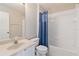 Bright bathroom features a vanity, toilet, and bathtub with shower at 13519 Bicton Ln, Windermere, FL 34786