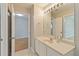 Bathroom with a large mirror, vanity and tile floor at 13519 Bicton Ln, Windermere, FL 34786