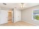 Bright bedroom features a ceiling fan, window, and closet at 13519 Bicton Ln, Windermere, FL 34786