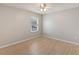 Bright bedroom with a window and wood-look flooring at 13519 Bicton Ln, Windermere, FL 34786