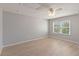 Cozy bedroom featuring a ceiling fan, hardwood floors, natural light, and neutral colored walls at 13519 Bicton Ln, Windermere, FL 34786