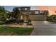 Inviting two-story home with a three-car garage and lush landscaping at 13519 Bicton Ln, Windermere, FL 34786