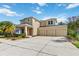 Charming two-story home with a three-car garage, landscaping, and ample parking at 13519 Bicton Ln, Windermere, FL 34786