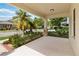 Inviting covered front porch with mature tropical landscaping at 13519 Bicton Ln, Windermere, FL 34786