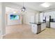 Kitchen and living area with stainless appliances, island and an open layout at 13519 Bicton Ln, Windermere, FL 34786