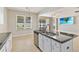 Kitchen island with sink and seating in an open floor plan at 13519 Bicton Ln, Windermere, FL 34786
