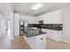Bright kitchen with stainless steel appliances, granite countertops, and white cabinetry at 13519 Bicton Ln, Windermere, FL 34786
