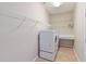 Bright laundry room featuring a full size washer and dryer, storage shelves, and tiled floors at 13519 Bicton Ln, Windermere, FL 34786