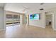 Open living room with sliding glass doors to the backyard, neutral walls, and tile flooring at 13519 Bicton Ln, Windermere, FL 34786