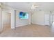 Living room showcasing tile floors, a ceiling fan, and a mounted television at 13519 Bicton Ln, Windermere, FL 34786