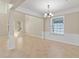 Bright living room featuring tile flooring, large windows, and wainscoting detail at 13519 Bicton Ln, Windermere, FL 34786
