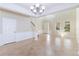 Airy living room featuring tile flooring, natural light and a modern chandelier at 13519 Bicton Ln, Windermere, FL 34786