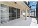The covered patio features large sliding doors, a ceiling fan, and access to the backyard at 13519 Bicton Ln, Windermere, FL 34786