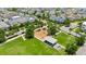 Aerial view of a neighborhood park offering green spaces and recreational equipment surrounded by charming houses at 13618 Heaney Ave, Orlando, FL 32827