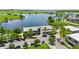 Stunning aerial view of a lakeside community center with palm trees and ample parking spaces available at 13618 Heaney Ave, Orlando, FL 32827