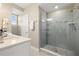 Bright bathroom with a glass shower, neutral tile, and white vanity at 13618 Heaney Ave, Orlando, FL 32827