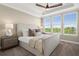 Comfortable bedroom featuring large windows, neutral colors, and a ceiling fan at 13618 Heaney Ave, Orlando, FL 32827