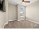 This bedroom features carpet, a ceiling fan, a window, and neutral paint at 13618 Heaney Ave, Orlando, FL 32827